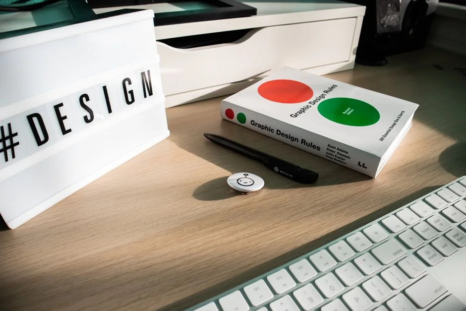 A modern computer screen displaying web design work, showcasing creative visuals in a workspace.