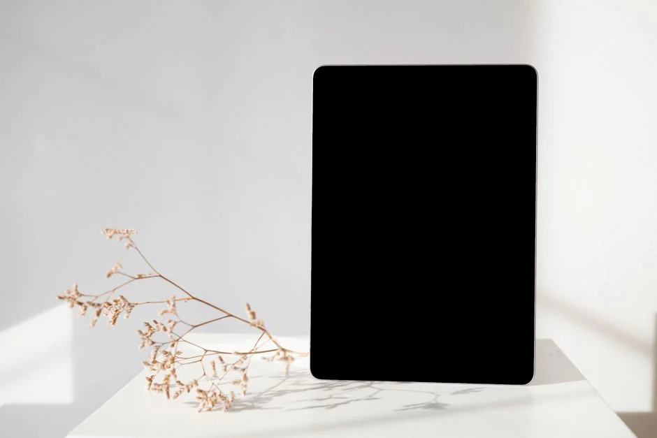 A tablet with a financial website open, alongside a white keyboard and mouse. Ideal for tech-theme stock images.